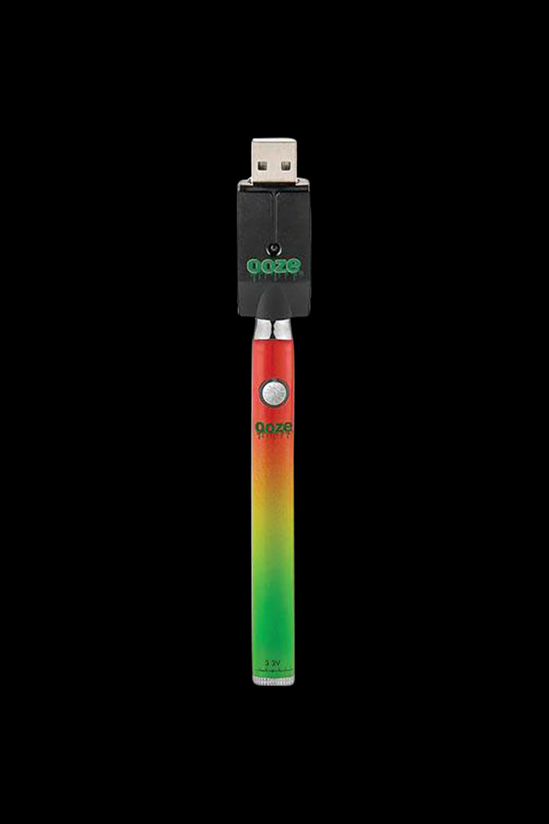 Centered front view of the purple Ooze Slim Twist Battery with Charger showing a gradient red-to-green pen body and its USB charger against a black background