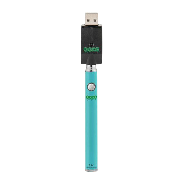 Top-down view of a turquoise Ooze Slim Twist Battery with Charger showing the battery's button and the black USB charger plugged in.