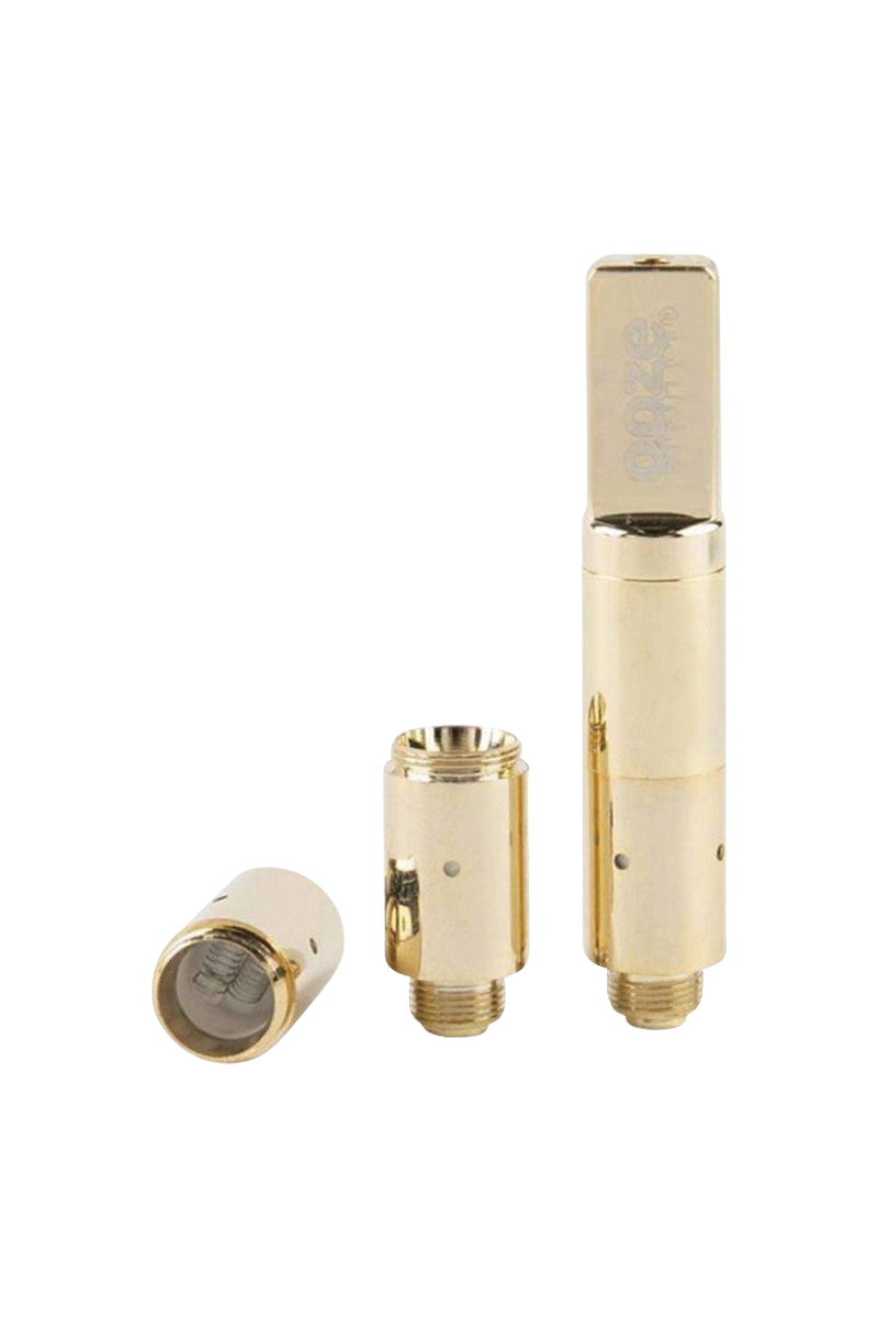 Three gold-tone metal components of the Ooze Slim Twist Pro Wax Atomizer Tank shown upright and lying down on a white background.
