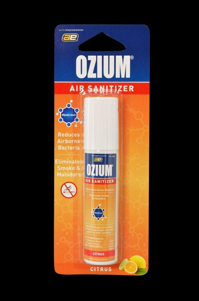 Front view of a packaged Ozium Scented 0.8oz Air Sanitizer in citrus-themed orange and blue blister card with the white-topped spray can visible.