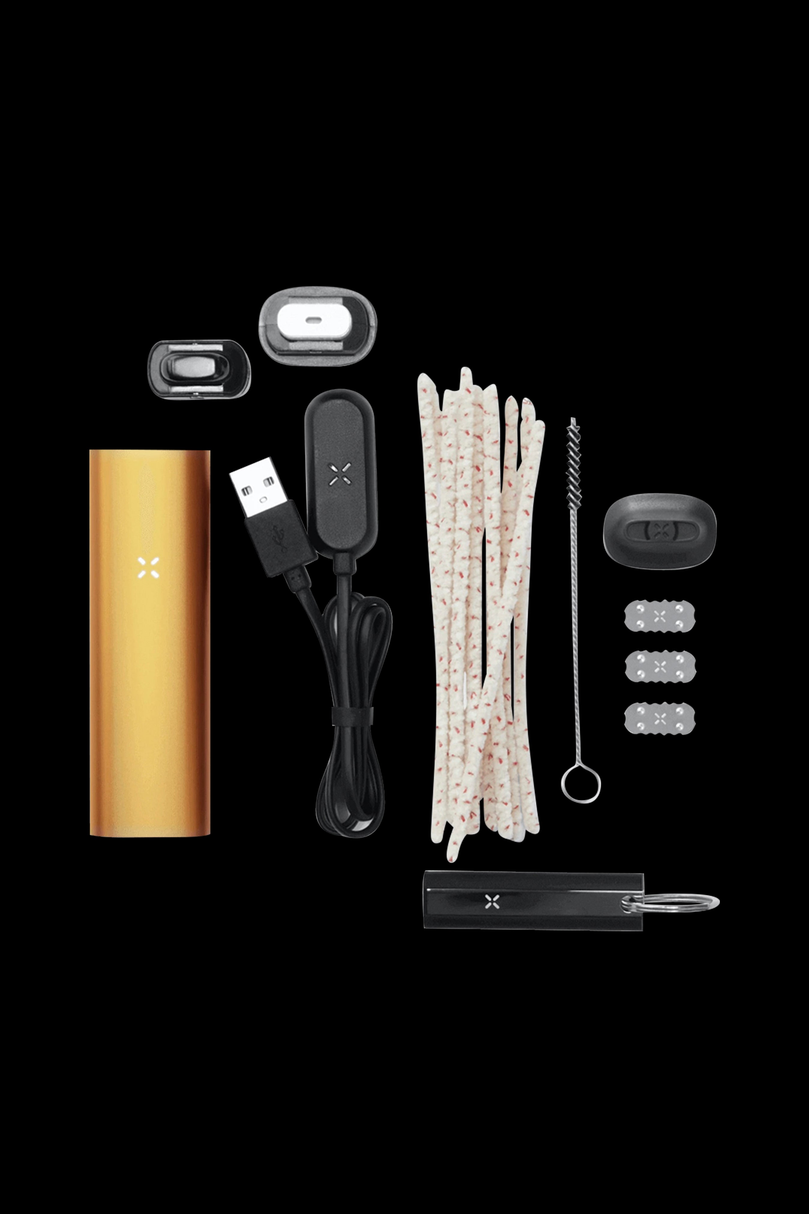 Pax Plus cannabis vaporizer kit components laid out on a black background, including the device, charging cable, oven lids, and cleaning tools.