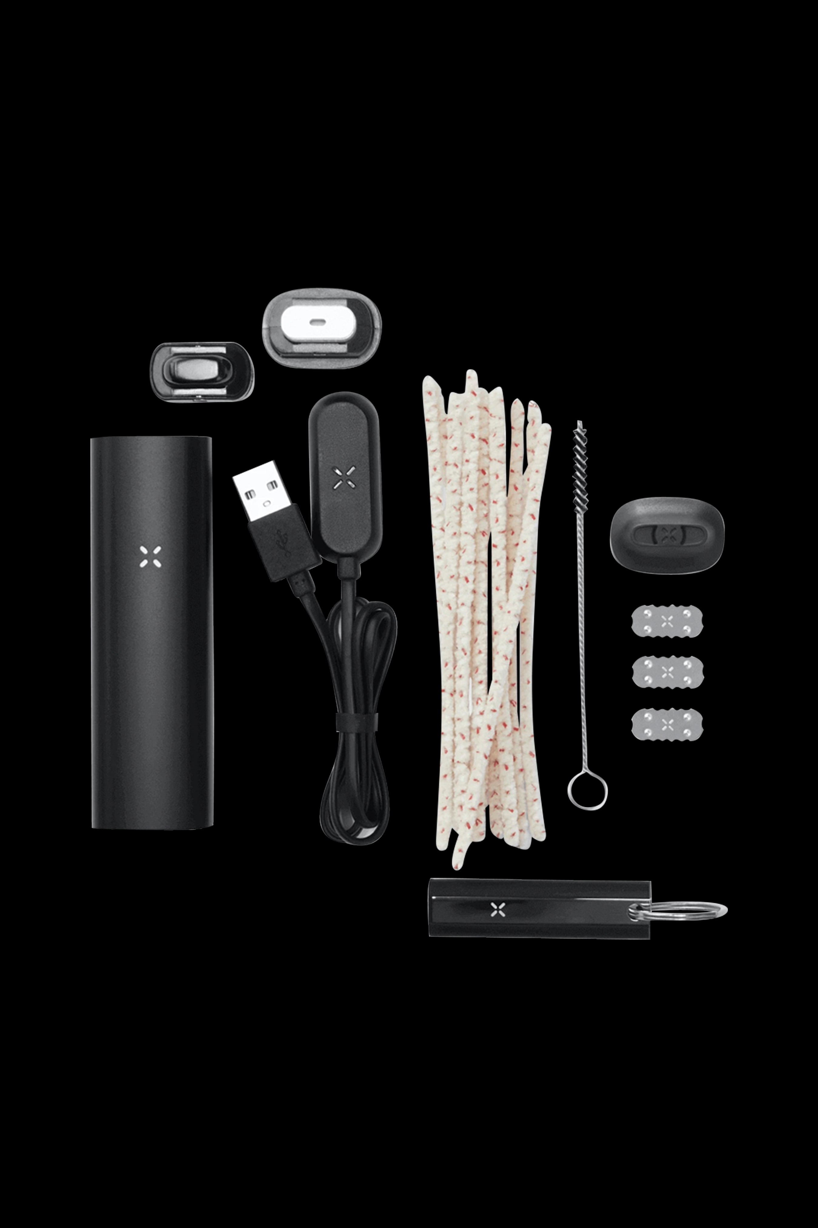 PAX Plus cannabis vaporizer kit including device, charging cable, oven lids, and accessories, arranged on a dark background.