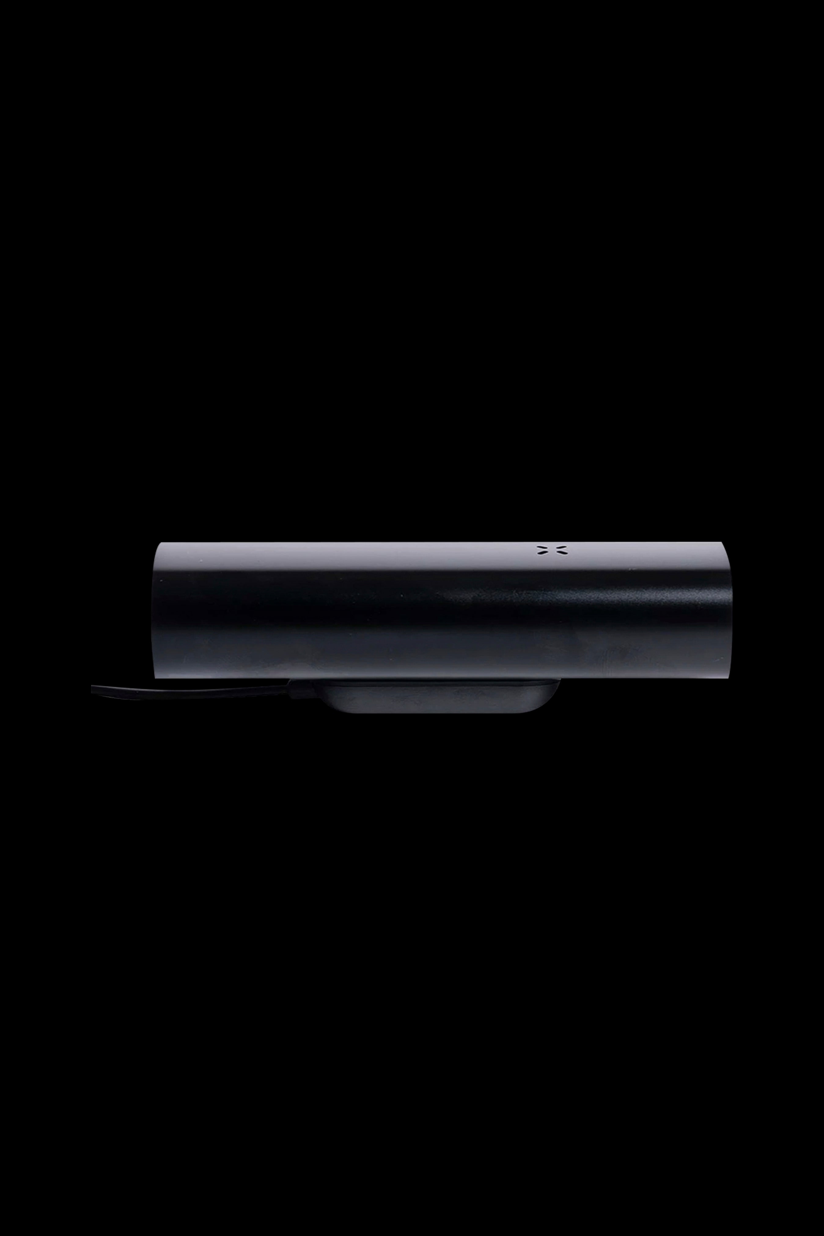Sleek black cannabis vaporizer pen on charging base.
