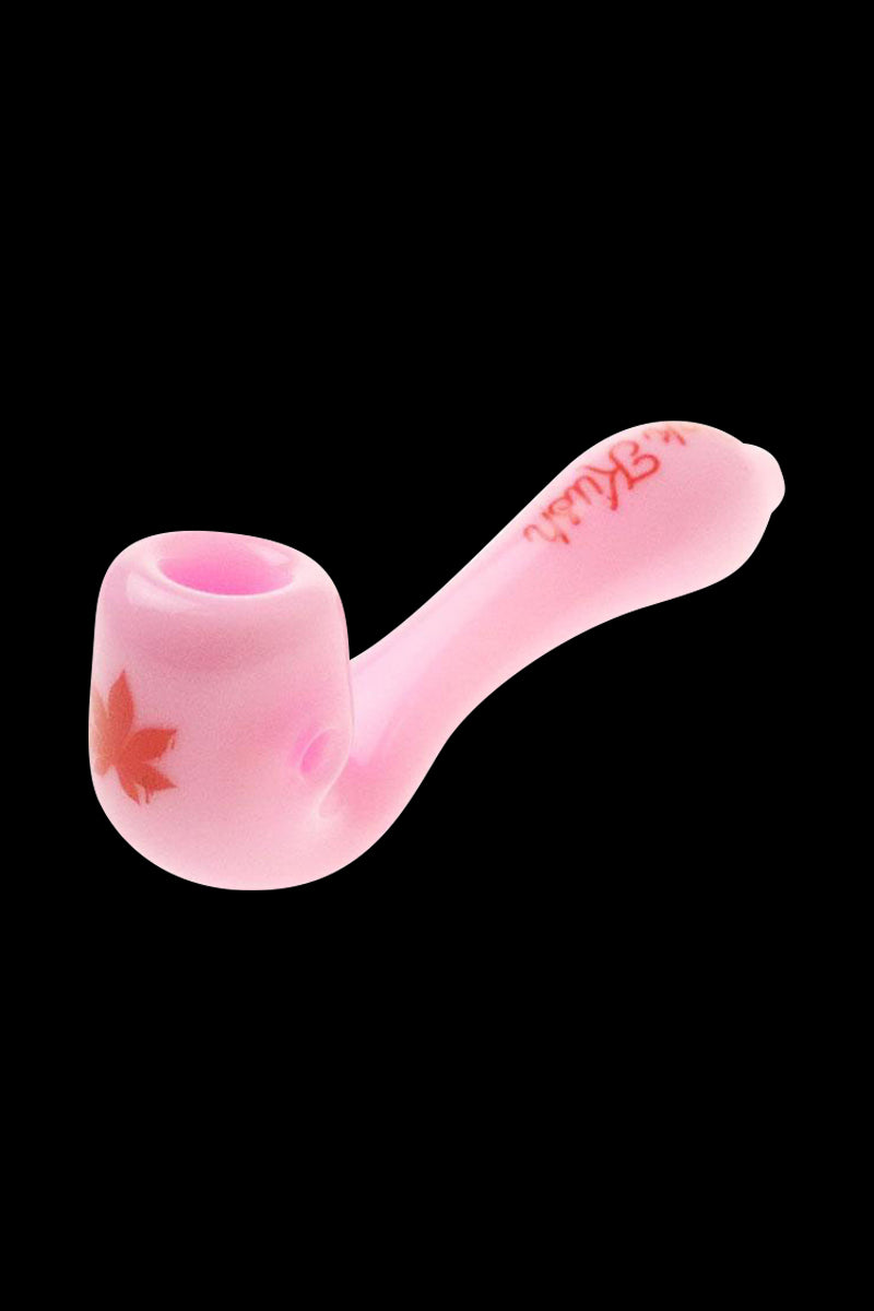 A close-up of the “Puff Puff Pass “Pink Kush” Strain Pipe, showing a curved, pink glass pipe against a plain black background.