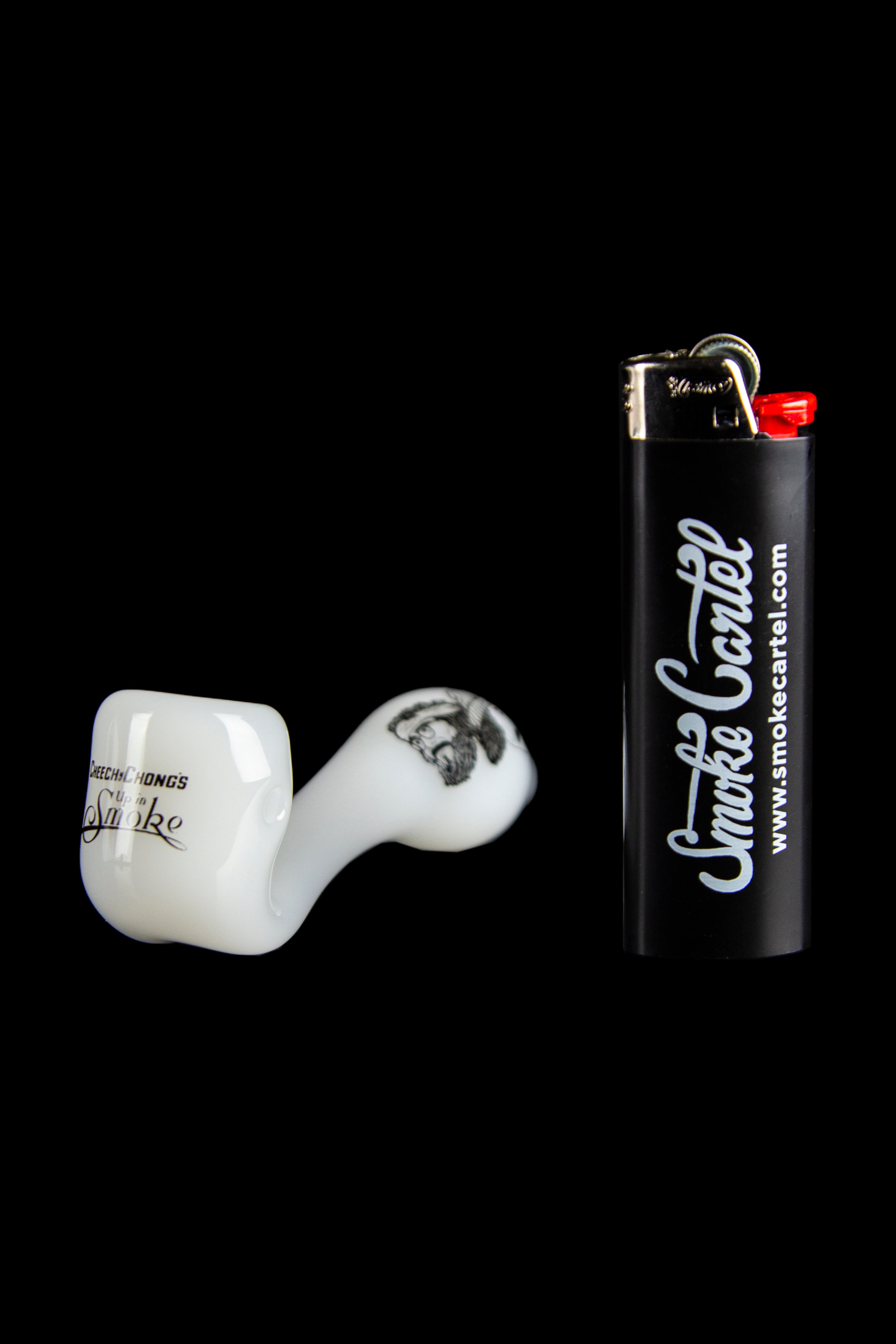 White glass pipe and black lighter with “Smoke Cartel” logo against a black background.