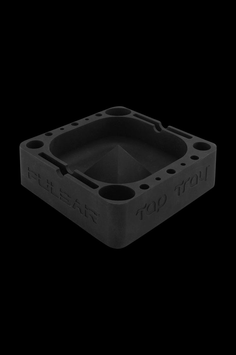 Angled top view of the black Pulsar Tap Tray showing its square recessed basin, corner holes, and embossed logo on a black background