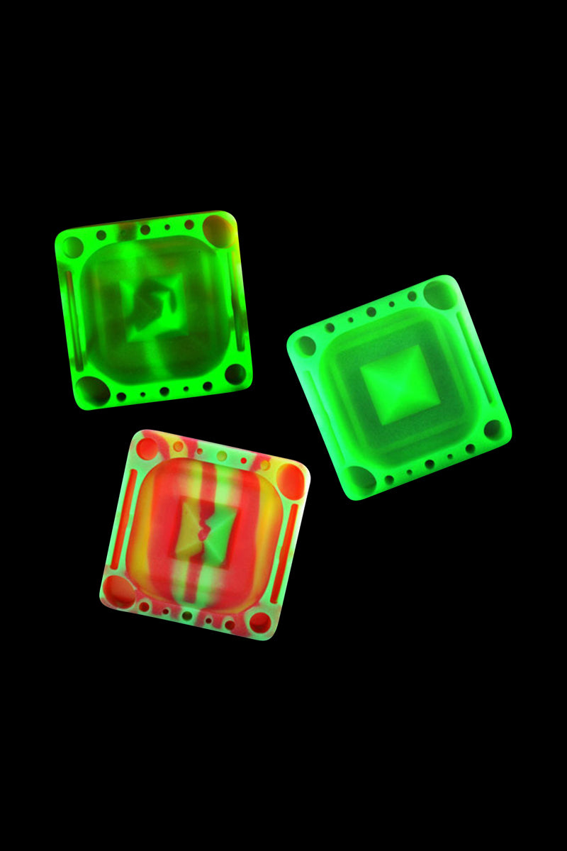 Three tilted Pulsar Tap Tray squares with neon green and red marbled centers set against a black background.