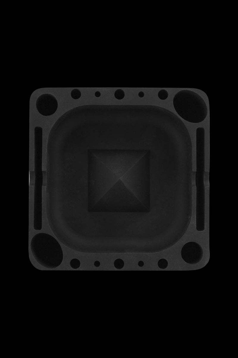 Top-down view of a square black Pulsar Tap Tray showing a recessed central bowl with a raised pyramid center and multiple round and slot compartments around the rim.