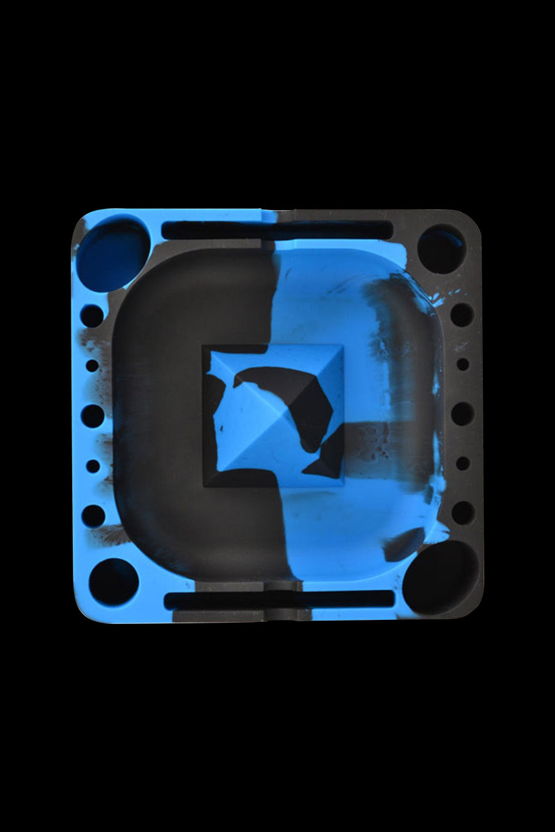 Top-down view of a square Tie Dye Pulsar Tap Tray showing black and bright blue molded compartments and rounded corner wells.