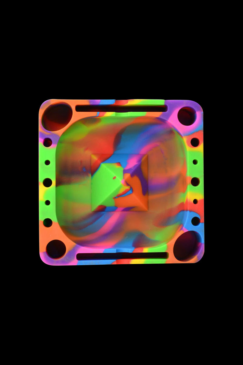 Top-down view of a square Rasta-colored Pulsar Tap Tray with swirling neon green, orange, purple, and blue patterns on black.