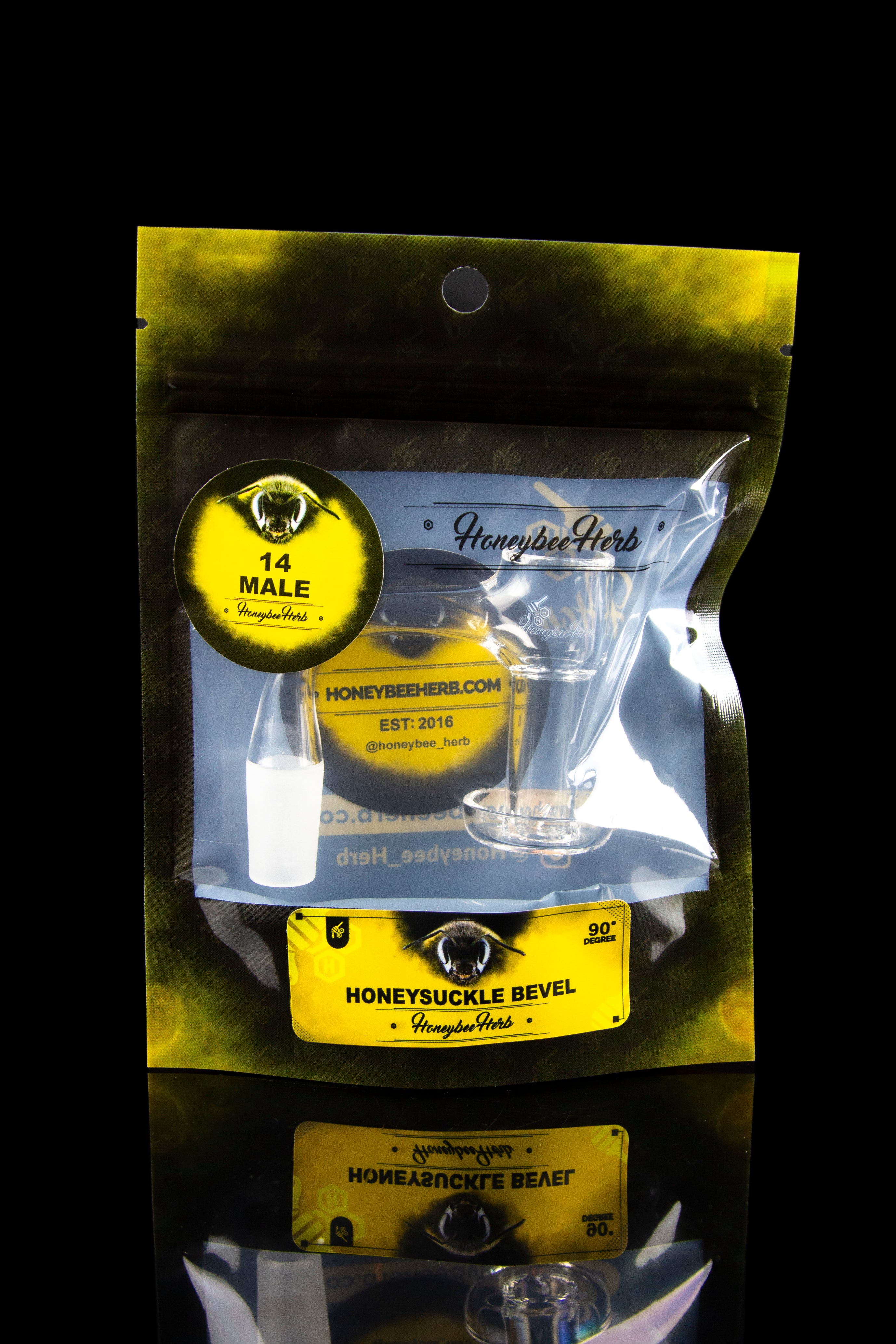 A sealed, yellow bag displaying cannabis accessories, including a glass pipe and bowl, branded with “Honeybee Herb” and “14 Male.”"