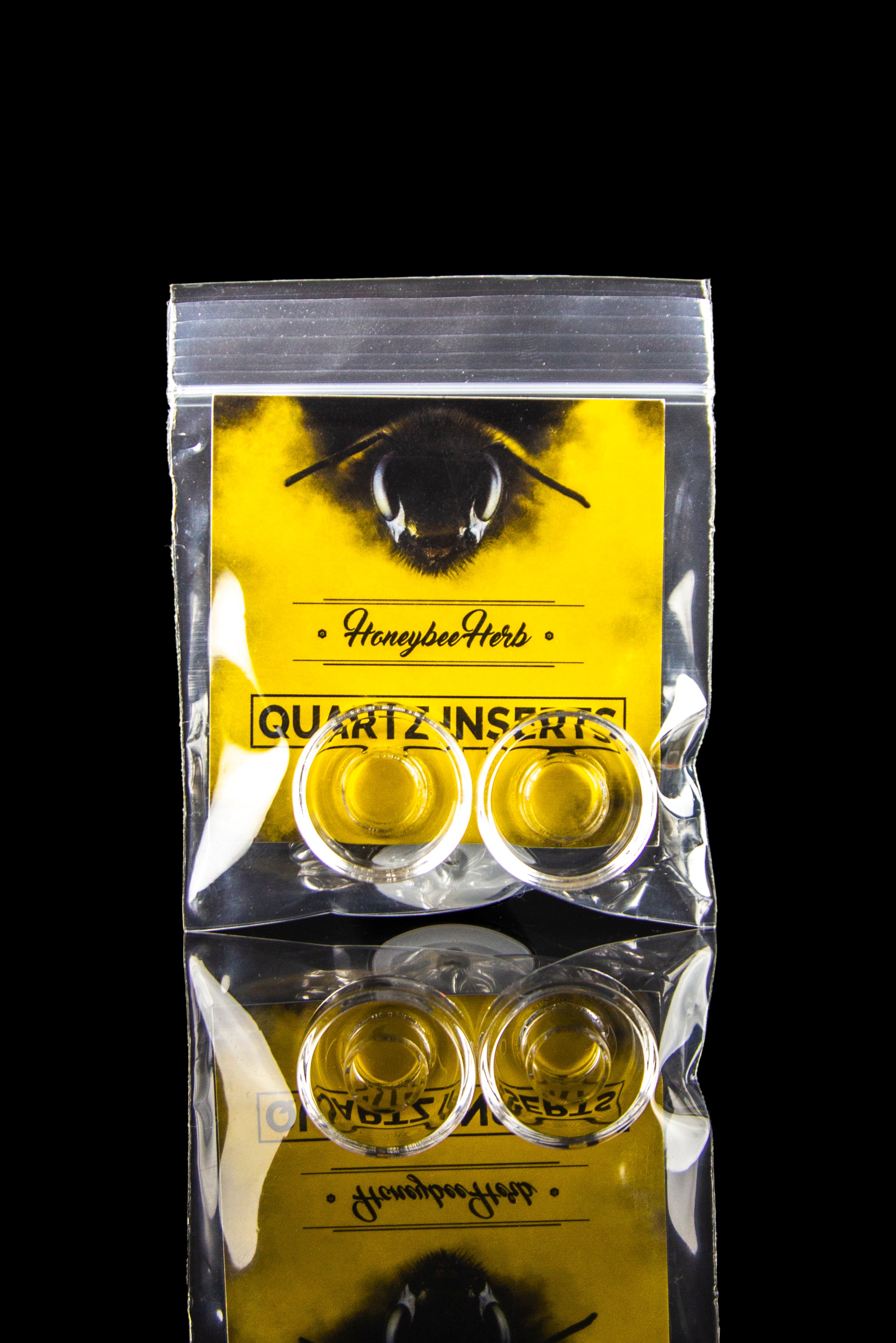 Plastic bag of “Honeybee Herb” quartz inserts for dabbing cannabis concentrates.