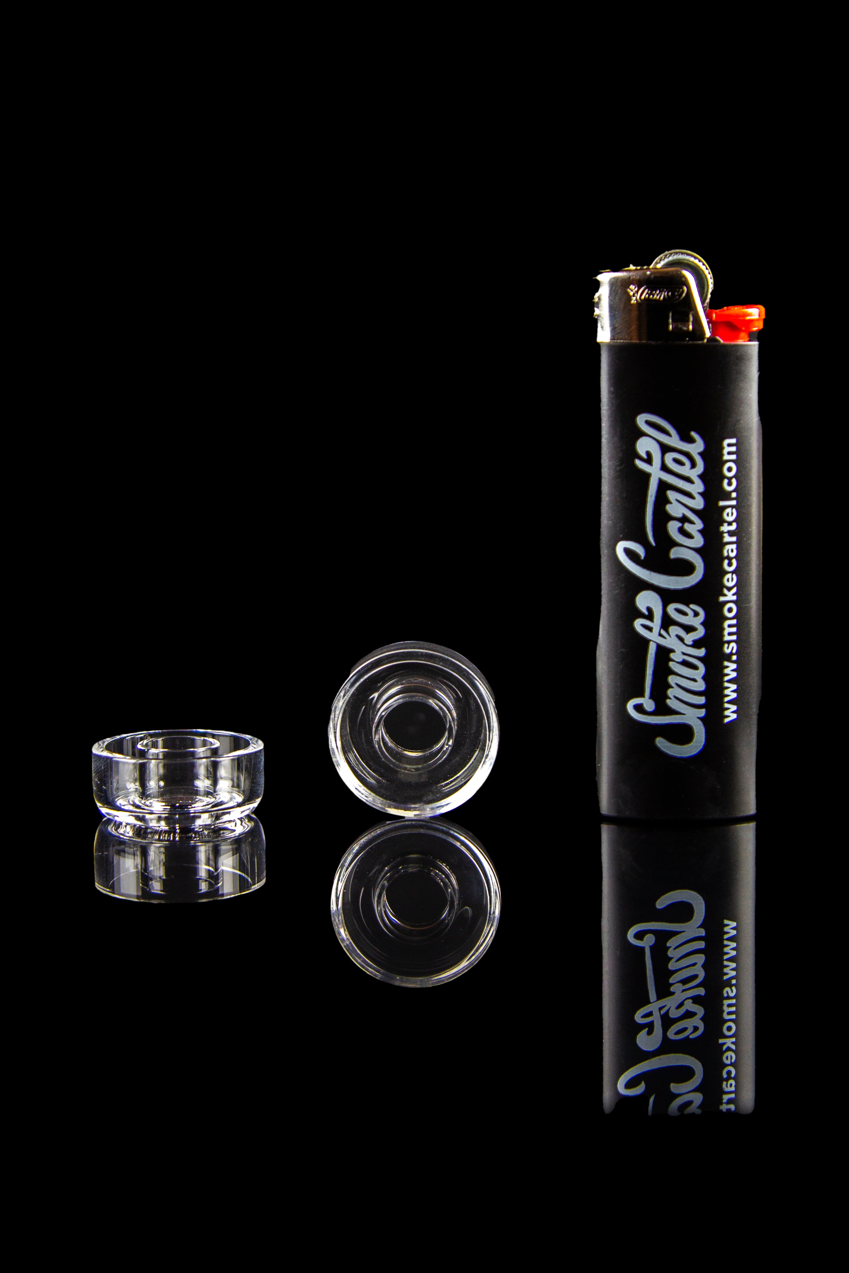 Clear glass cannabis concentrate containers and lighter with “Smoke Cartel” branding against a black background.
