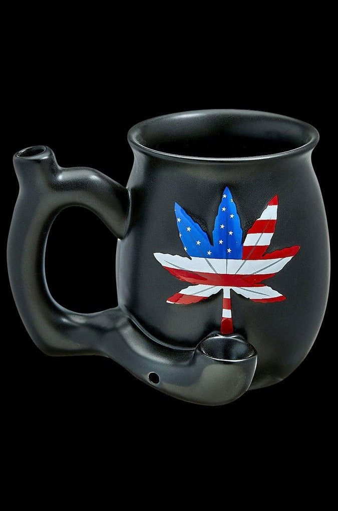 A close-up, angled view of the Roast & Toast Premium Ceramic Embossed Leaf Pipe Mug, featuring a detailed leaf design on its dark ceramic surface.