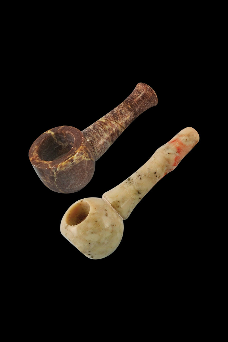 A close-up, angled view of the Round Small Stone Pipe - 6 Pack, showing a single, brown stone pipe against a dark backdrop.