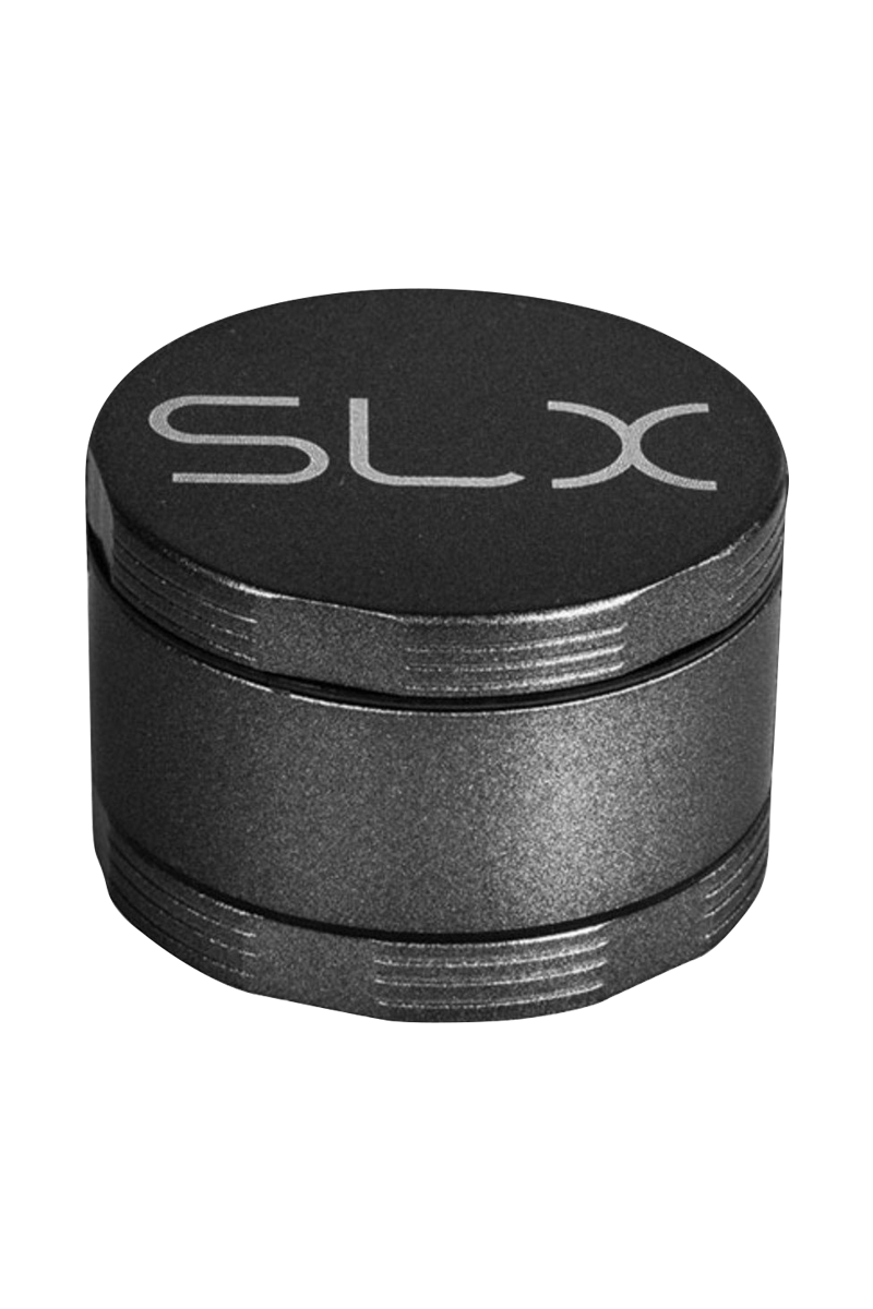 Angled close-up of the black SLX Ceramic Coated 2.2" Pocket Grinder showing its textured metal finish, stacked chamber profile, and recessed logo on top.