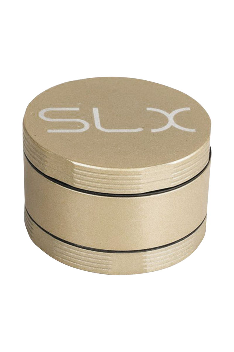 Angled close-up of the gold SLX Ceramic Coated 2.2" Pocket Grinder showing its stacked cylindrical layers and white SLX logo on top