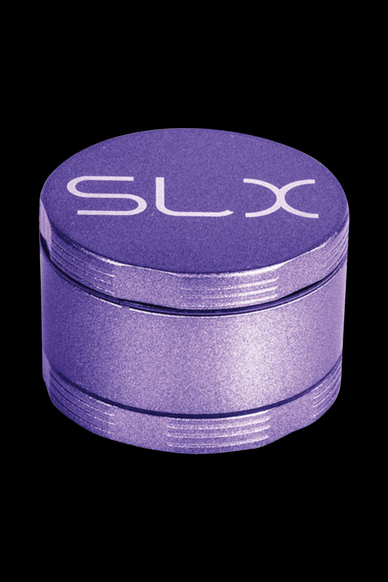 Close-up, slightly elevated view of the purple SLX Ceramic Coated 2.2" Pocket Grinder showing its textured lid with white "SLX" logo and stacked metal chambers against a black background