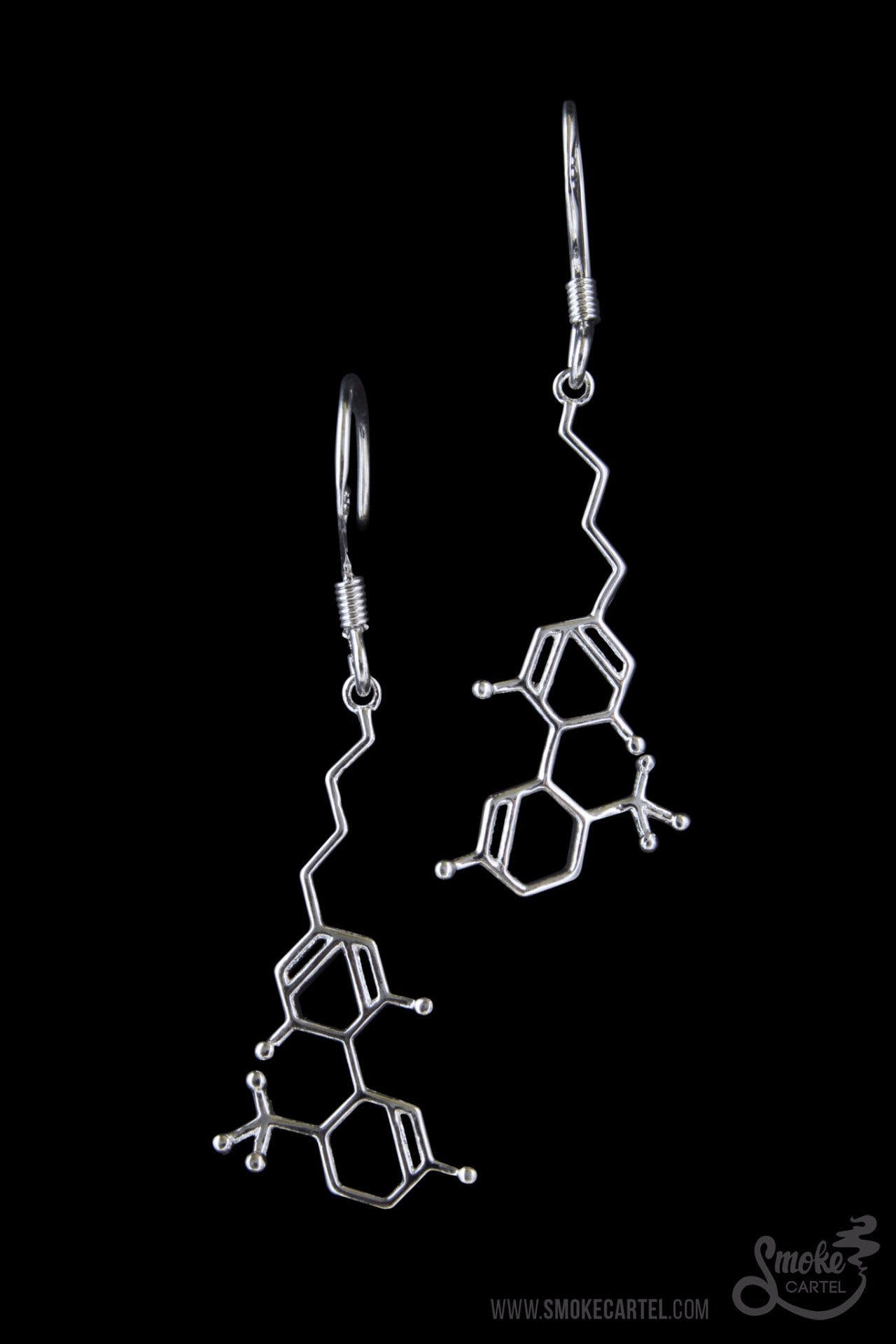 A detailed studio shot of the Smoke Cartel THC Molecule Earrings, showcasing the silver-toned, intricate molecular design.