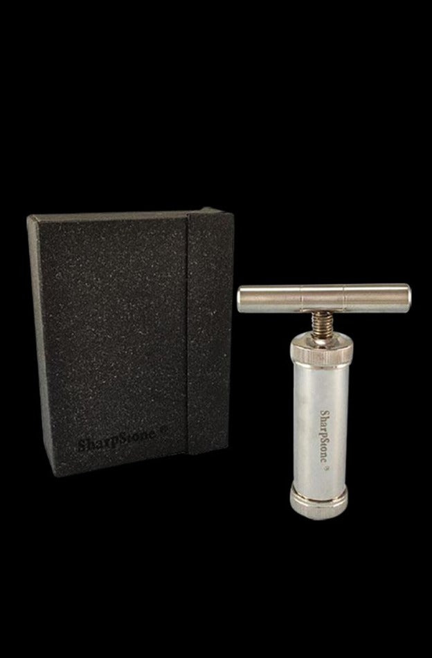 Studio-lit front view of the Sharpstone T-Style Press with Case showing the silver metal T-press upright beside its black foam-lined case.