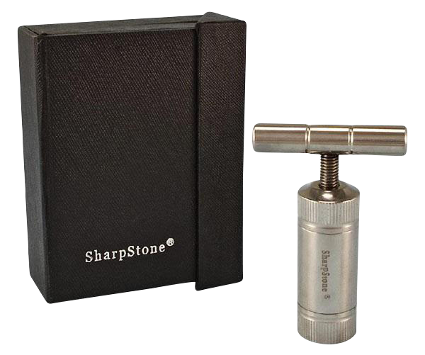 Right-side angled view of the Sharpstone T-Style Press with Case showing the stainless T-handle press standing beside its textured black branded case.