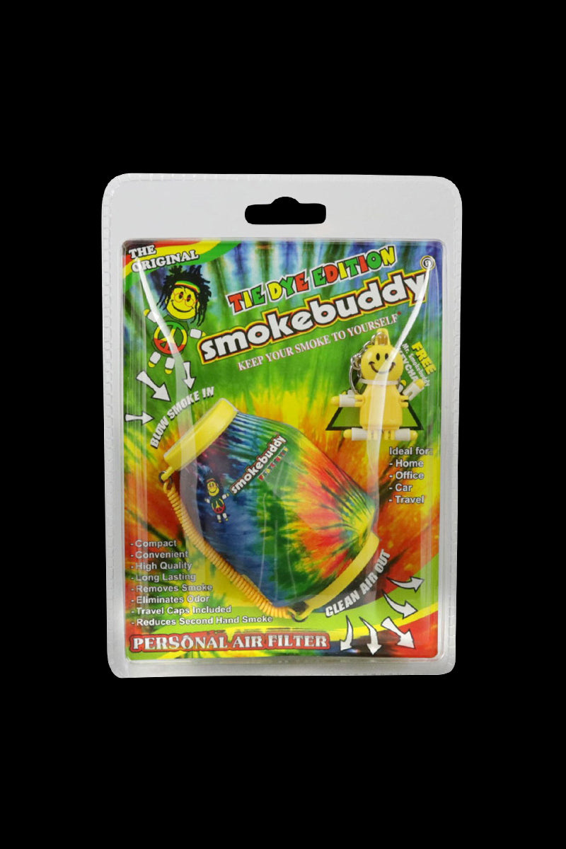 Front-facing shot of the tie-dye Smokebuddy Original Personal Air Filter in its blister pack against a black background.