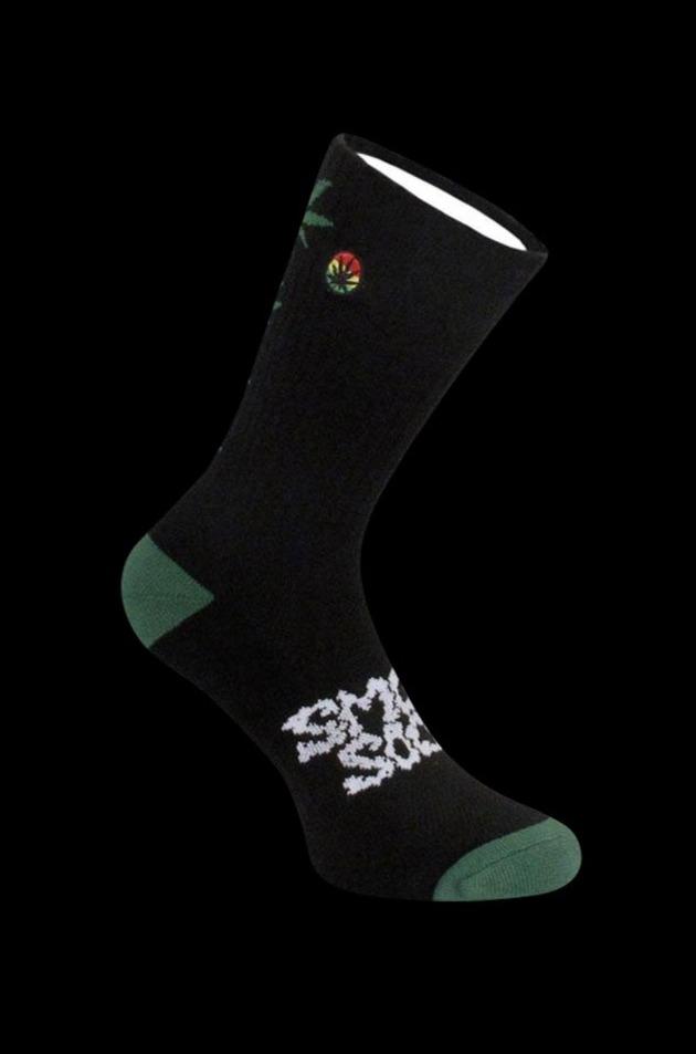 Smokey Brand Socks - Hemp Leaf Ladder 5.00% Off Auto renew, displayed in a close-up shot with a patterned sock angled against a dark background.