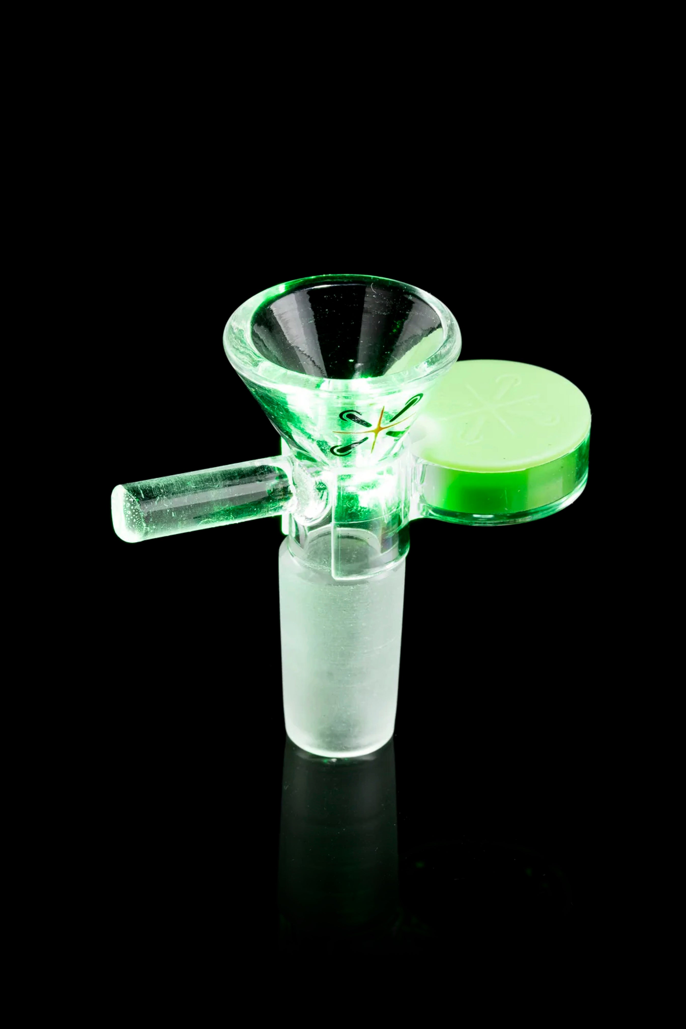 Glowing green glass bowl piece for smoking cannabis.