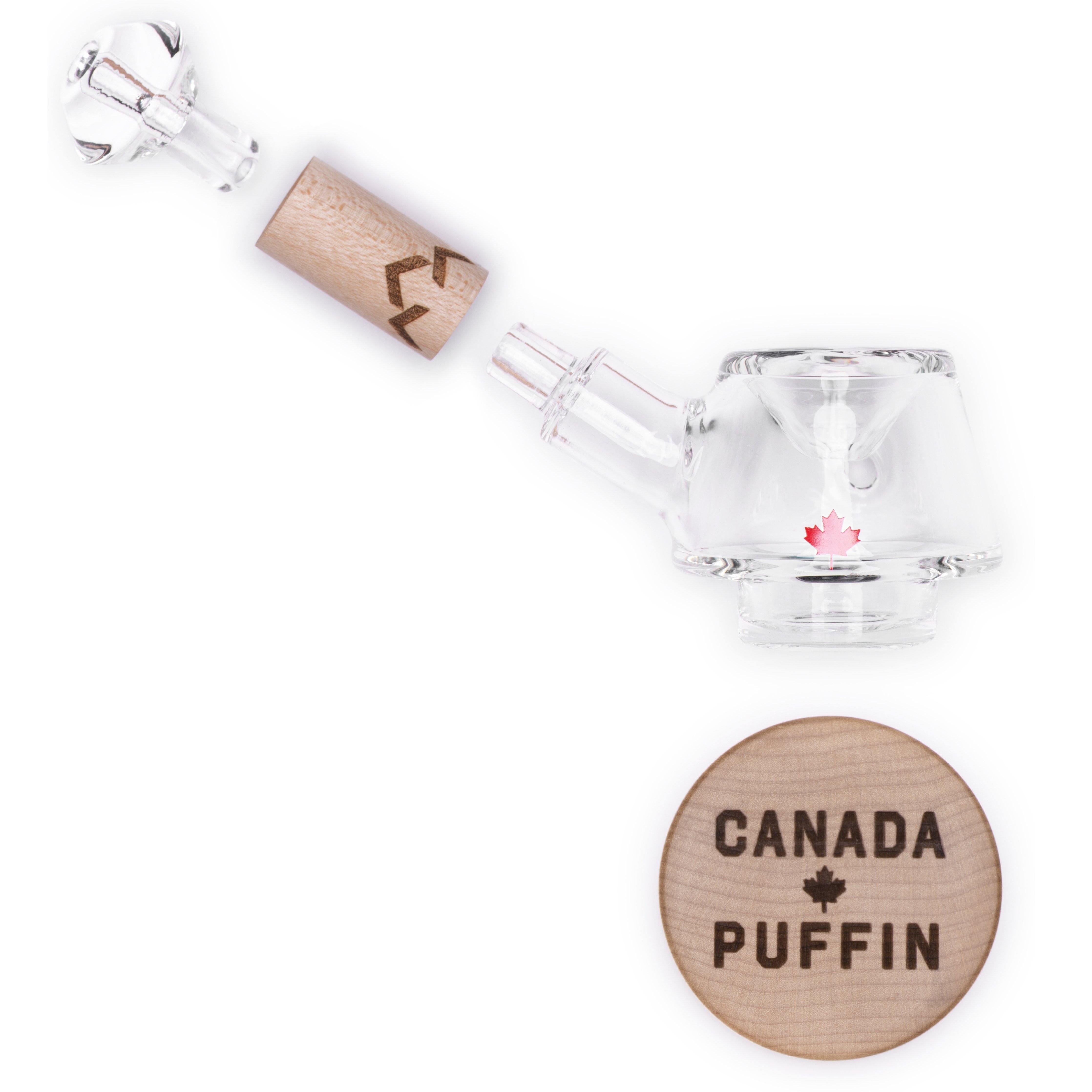A side view of the Canada Puffin Stone Spoon Pipe, a clear glass pipe angled against a plain white background.
