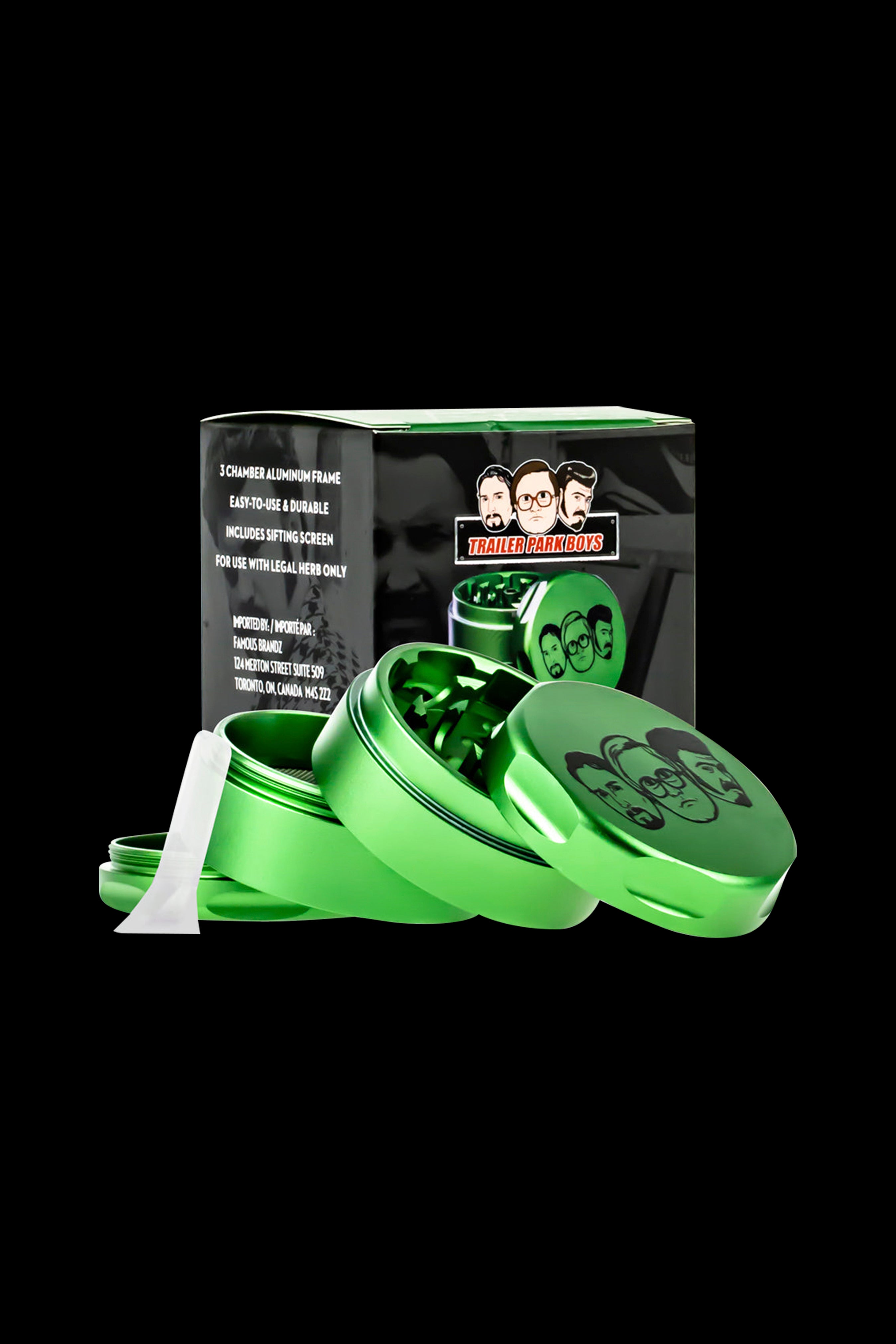 Green grinder with “Trailer Park Boys” branding, open to reveal ground cannabis inside.