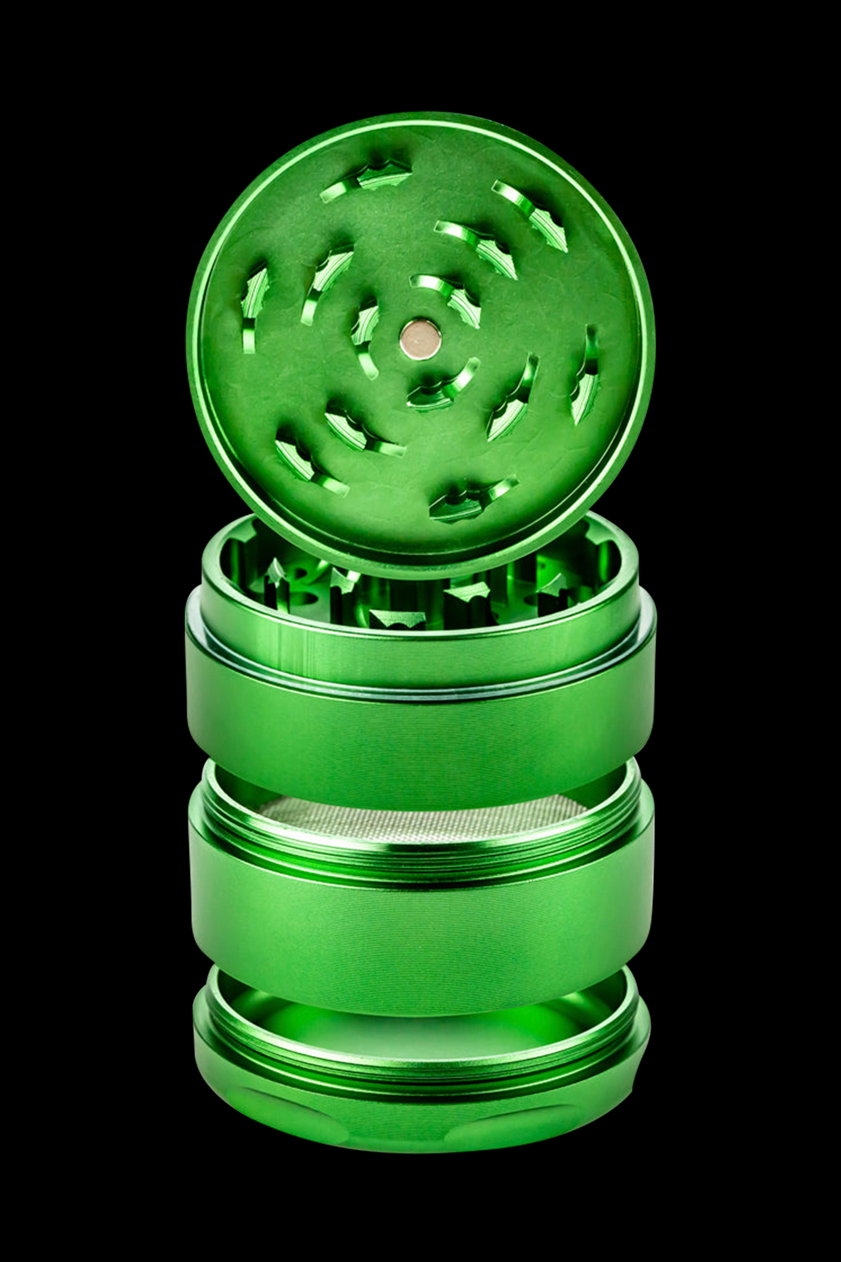 Green metal cannabis grinder with open lid revealing tiered chambers.
