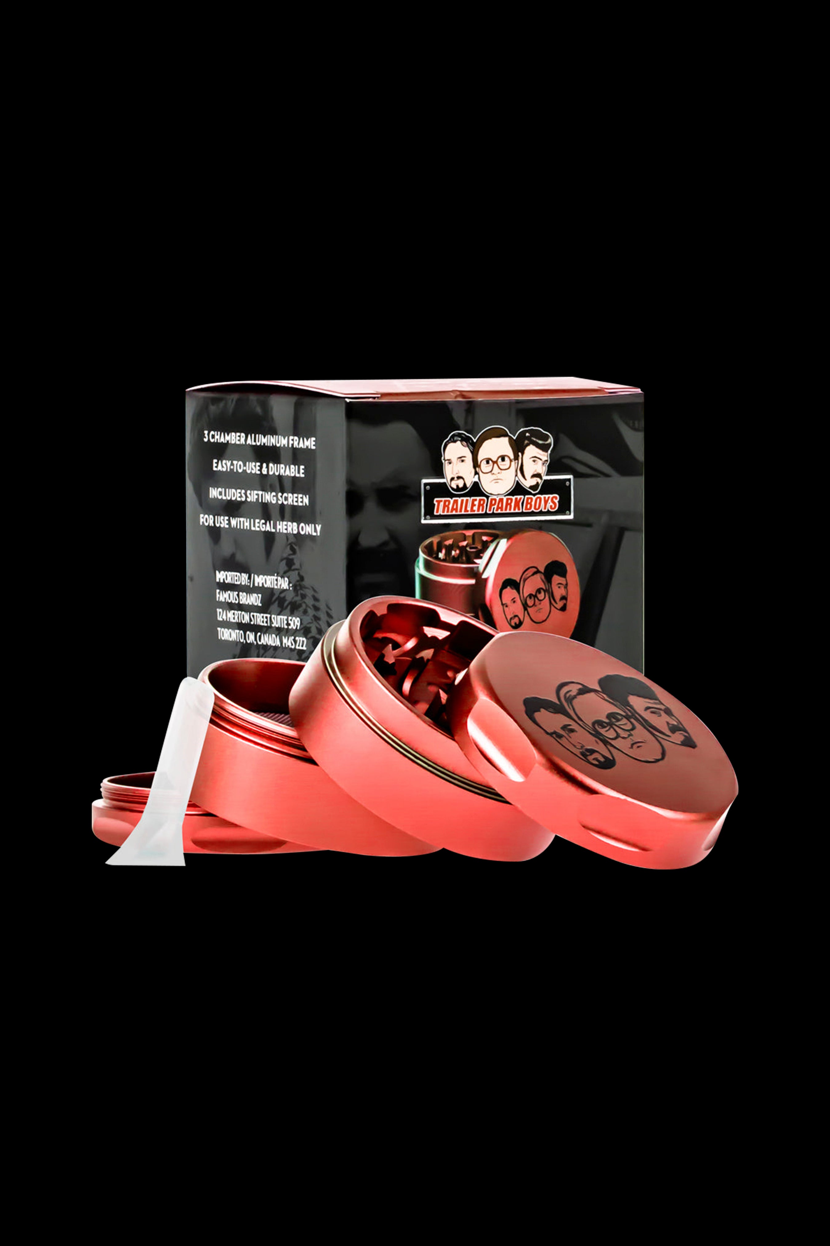 Red metal grinder with "Trailer Park Boys" branding, containing ground cannabis.