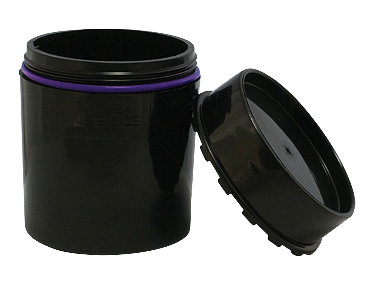 A slightly angled view of the open “Time Capsule” Sealable Storage Device, showing its dark interior and simple cylindrical form.