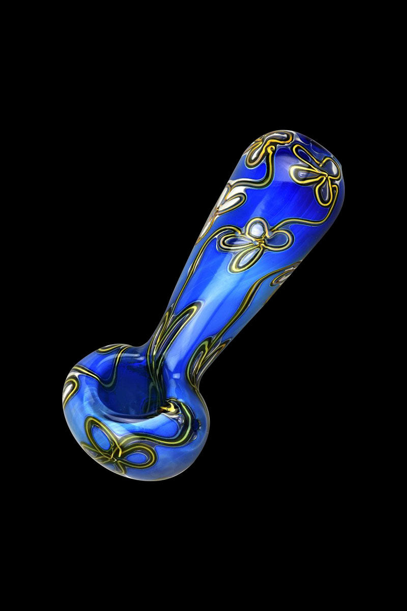 A side view of the Trippy Floral Double Glass Spoon Pipe, showcasing its colorful floral pattern on clear glass.