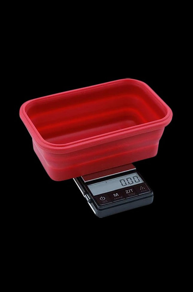 A close-up shows the Truweigh Crimson Collapsible Bowl Scale with a digital readout, angled against a dark backdrop.
