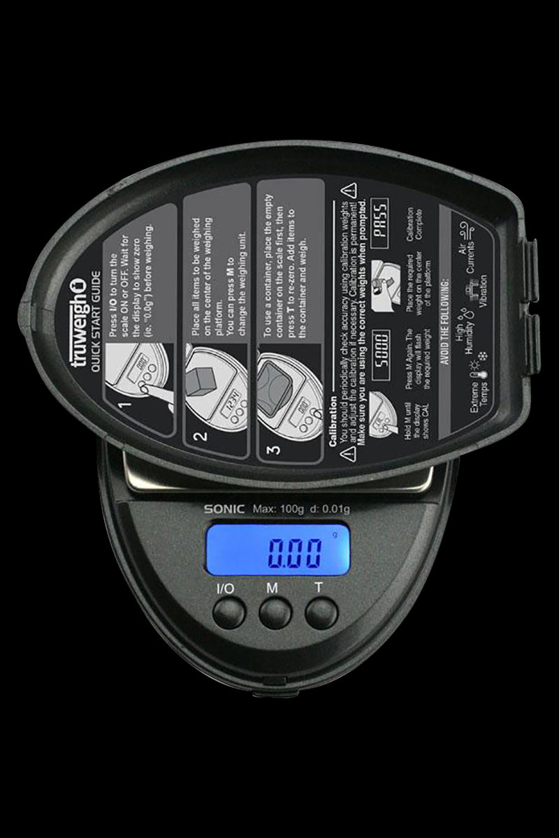 Close-up of the Truweigh Sonic Digital Mini Scale displaying a zero reading, with instructional text visible on its surface.