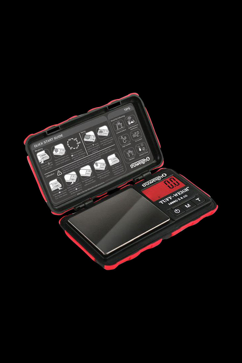 A top-down view of the Truweigh Tuff-Weigh Mini Scale, showcasing its digital display and open lid on a dark surface.