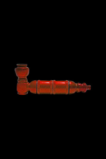 Red glass pipe on a black background.