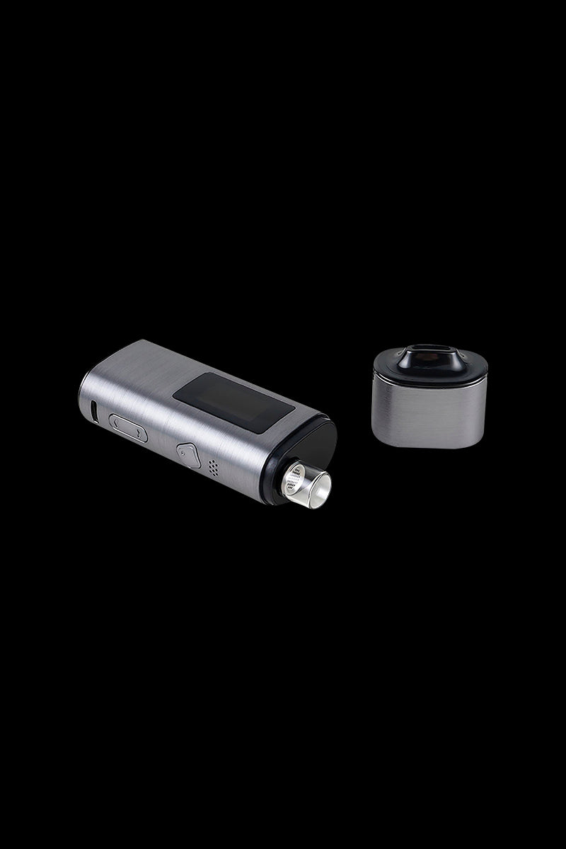 Sleek, silver cannabis vaporizer pen and detachable heating chamber on a black background.