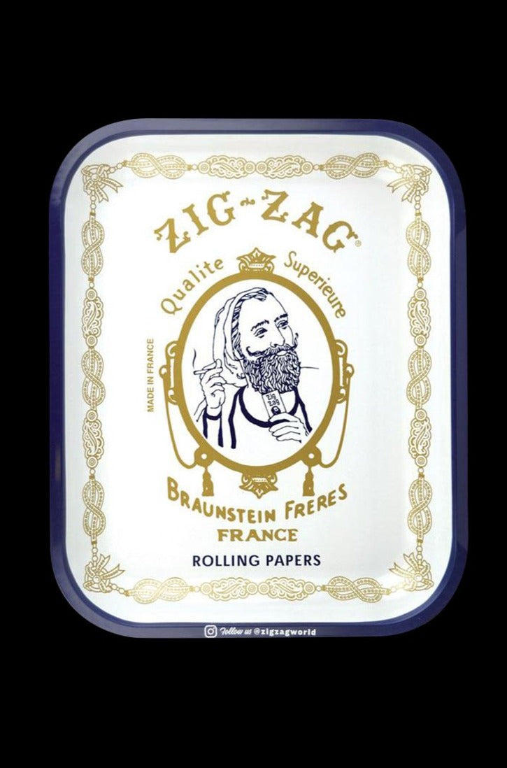 Overhead view of the Large Zig Zag Original Rolling Tray displaying vintage branding on a patterned surface.