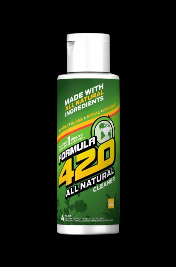 Centered front view of a green-labeled Formula 420 All Natural Glass Cleaner bottle against a black background.