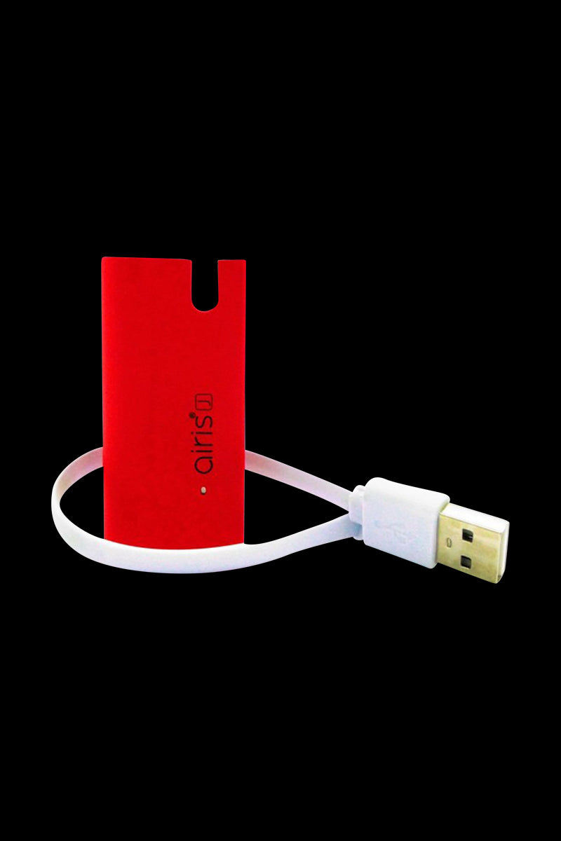 Centered front view of a red Airis J Salt & E Juice Vaporizer standing upright with its white USB charging cable looped beside it on a black background