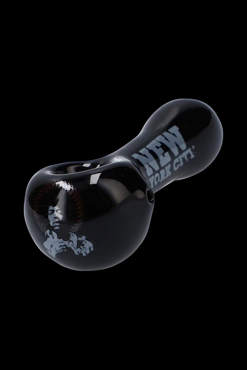 Angled close-up of the black Rock Legends Glass Spoon Pipe - Jimi NYC showing a glossy finish, Jimi Hendrix portrait and "New York City" text.