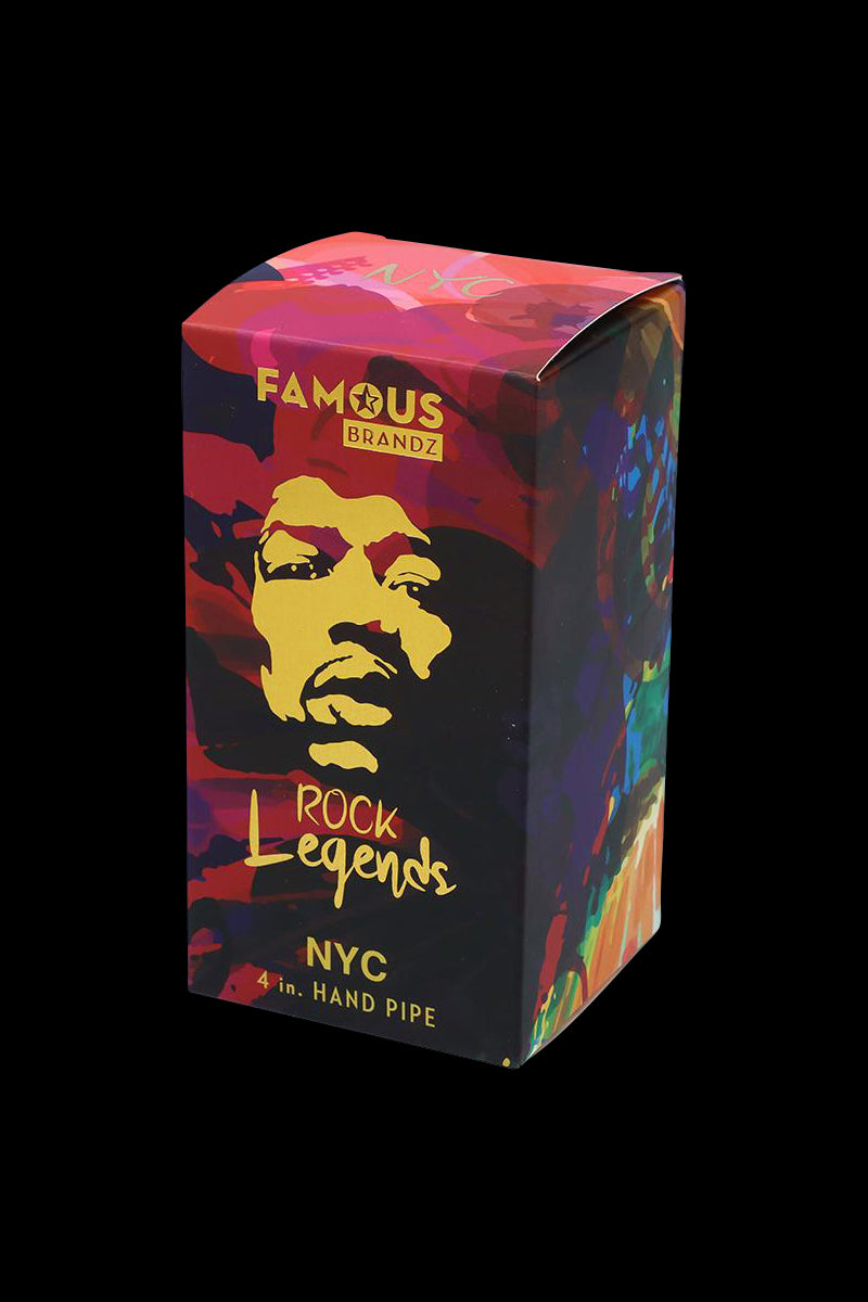 Angled front view of the Rock Legends Glass Spoon Pipe - Jimi NYC box showing colorful pop‑art portrait graphics and gold lettering on a black background