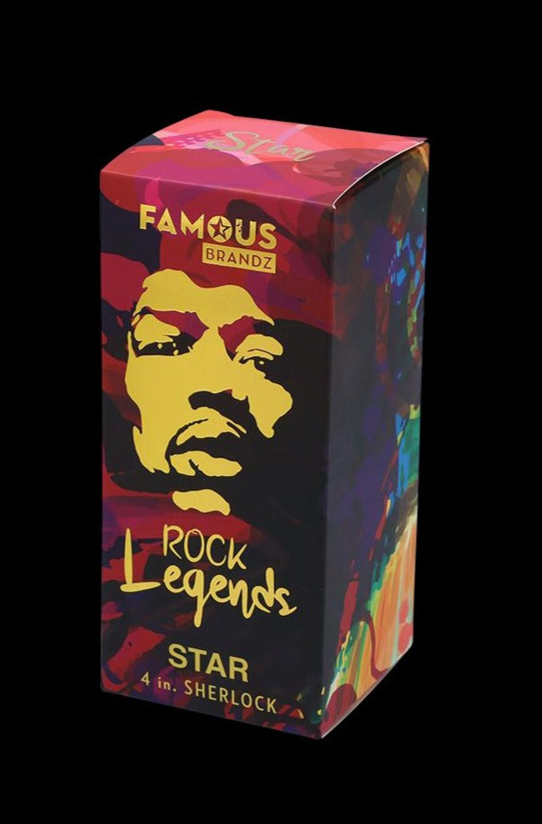 Angled studio shot of the Rock Legends Glass Sherlock Pipe - Jimi Star box showing a colorful pop-art face and gold "Rock Legends" text on a black background
