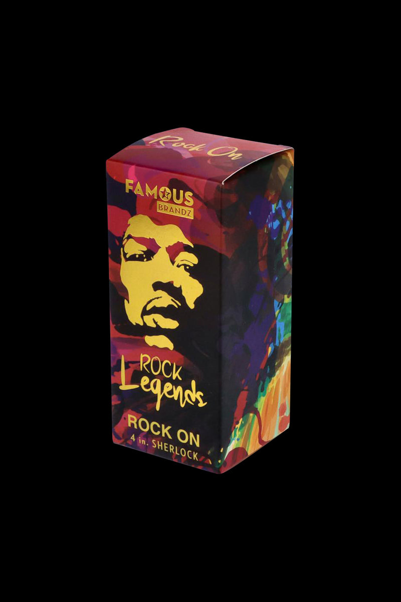 Angled front view of the Rock Legends Glass Sherlock Pipe - Jimi Rock On colorful boxed packaging with a stylized yellow face and "Rock Legends" text on a black background