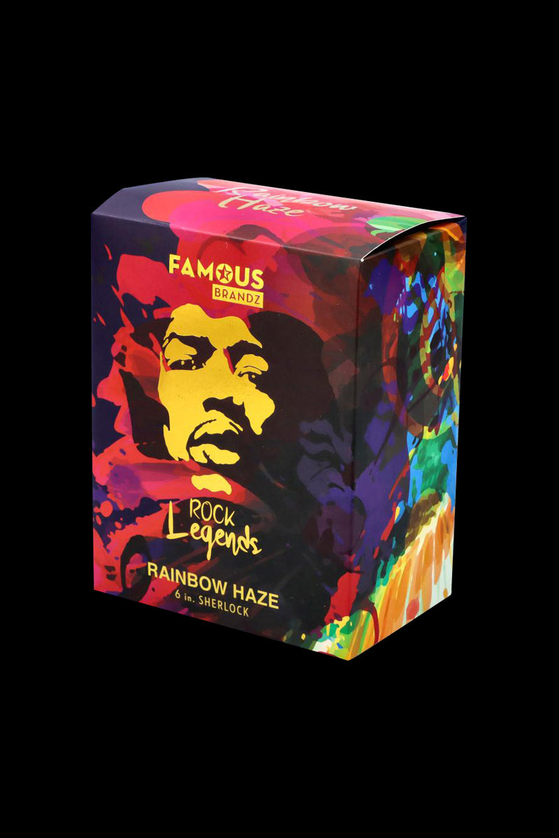 Three-quarter view of the colorful Rock Legends Sherlock Hammer Pipe - Jimi Rainbow Haze box with a yellow face silhouette and swirling rainbow patterns on a black background