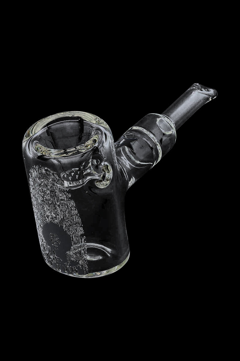 Angled close-up of the Rock Legends "Jimi Love" Sherlock Hammer Pipe against a black background, showing its clear glass bowl, stem and etched portrait.