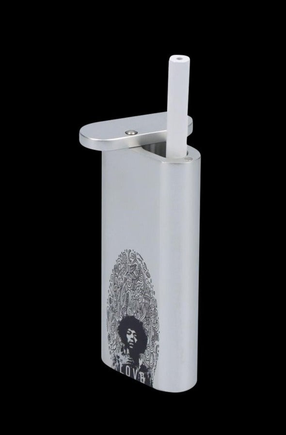 Angled front view of the Rock Legends "Jimi Love" Aluminum Dugout against a black background, showing its flip-top, white removable tube, and Jimi Hendrix portrait artwork.