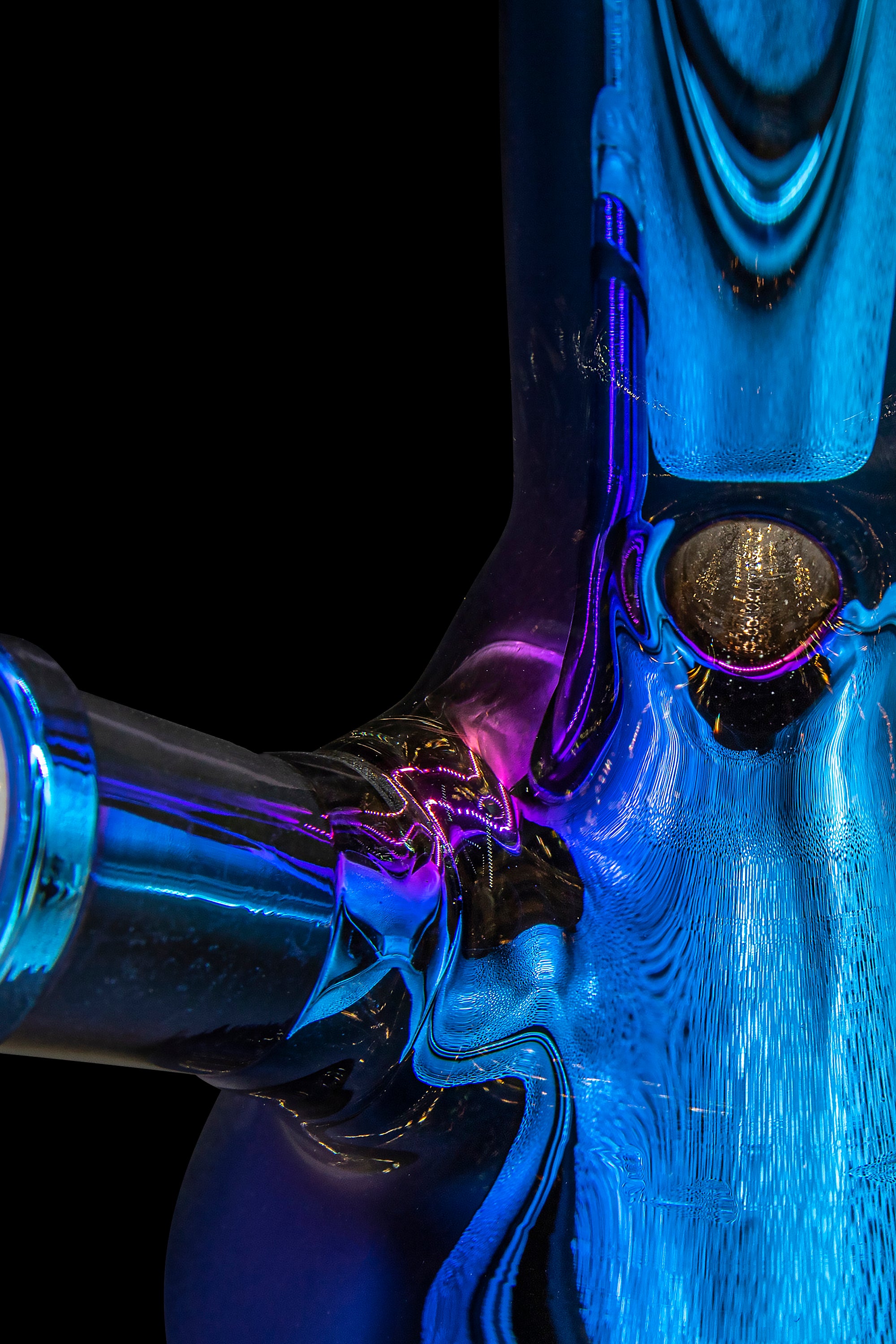 Abstract close-up of a glass cannabis pipe with vibrant blue and purple hues.